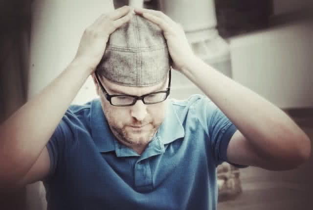 Chad Beall Putting On Hat